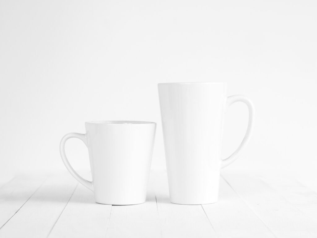 2 white ceramic mugs on white table