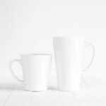 2 white ceramic mugs on white table